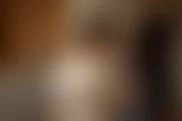 Bride getting ready by window in hall of Newberry Library