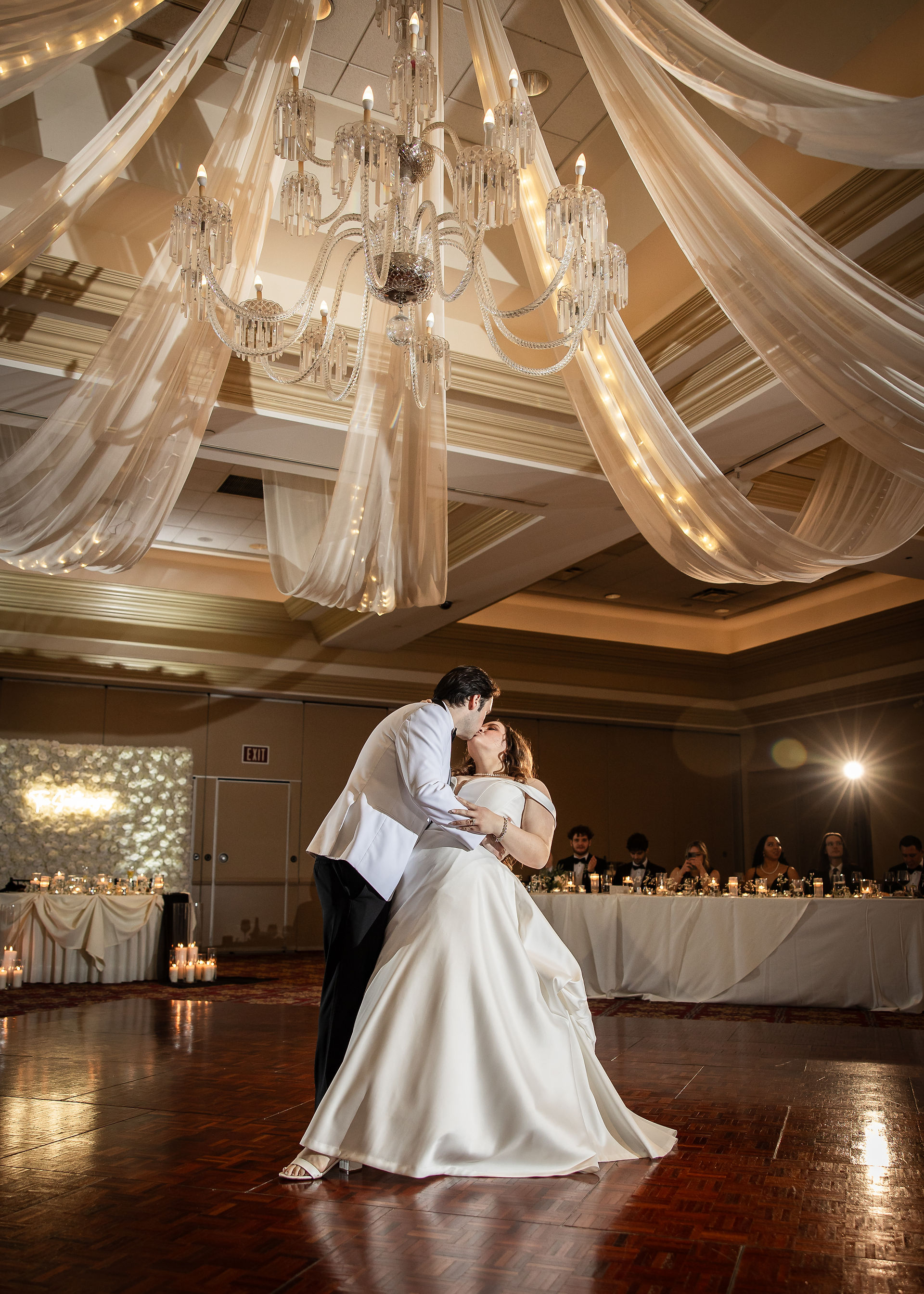 bride and groom kissing in the middle of reception dance floor 