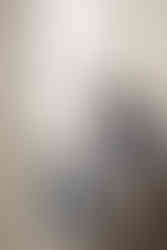 Mom and dad sitting in nursery looking at newborn