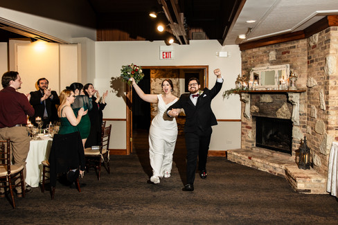 Bride and groom excitedly run into room