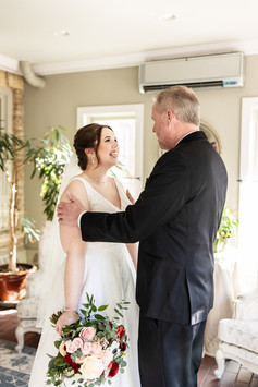 Bride and dad smiling during first look