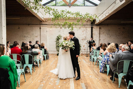 Bride and groom kissing during wedding ceremony at The Joinery