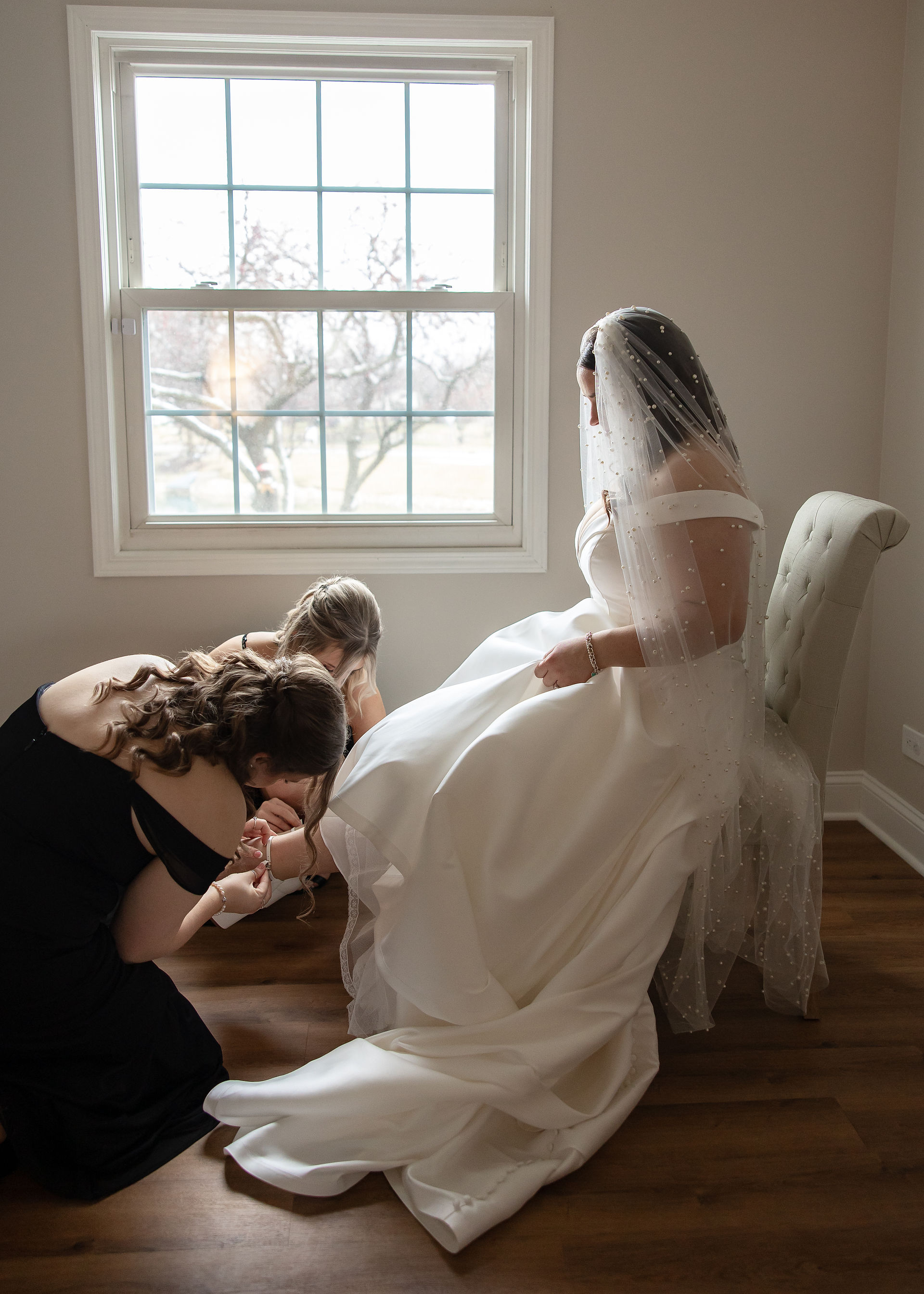 bridesmaids helping bride get ready