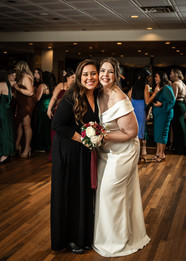 bride posing with women who caught the bouquet