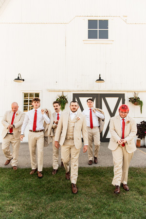 Groomsmen laughing while walking 