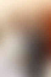 bride and groom walking while looking at each other in front of building with red doors