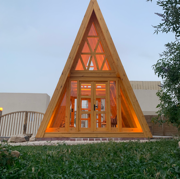 A-frame wooden house with glass doors and windows
