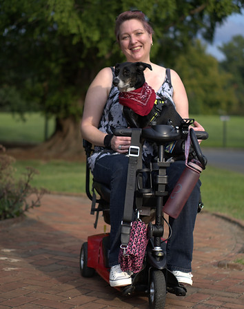 Woman on motorized scooter with service dog