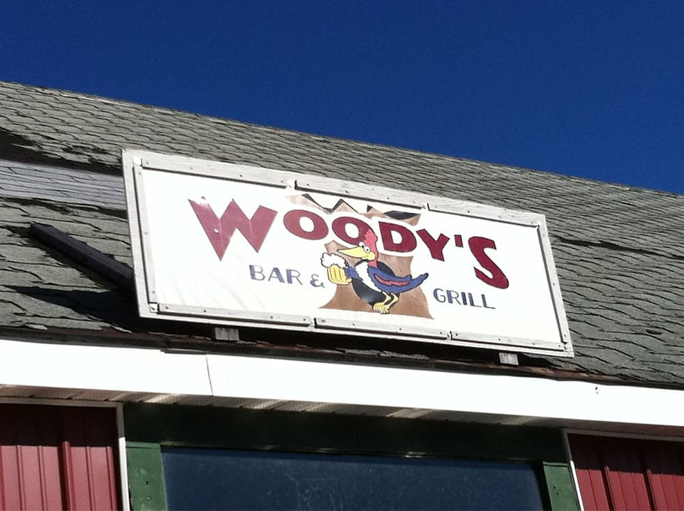sign of Woody's Bar & Grill in front Pub