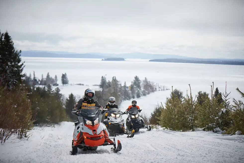 3 snowmobiles leaving the lake area and entering the vast Maine's ITS trail system.