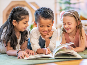 kids reading a book together