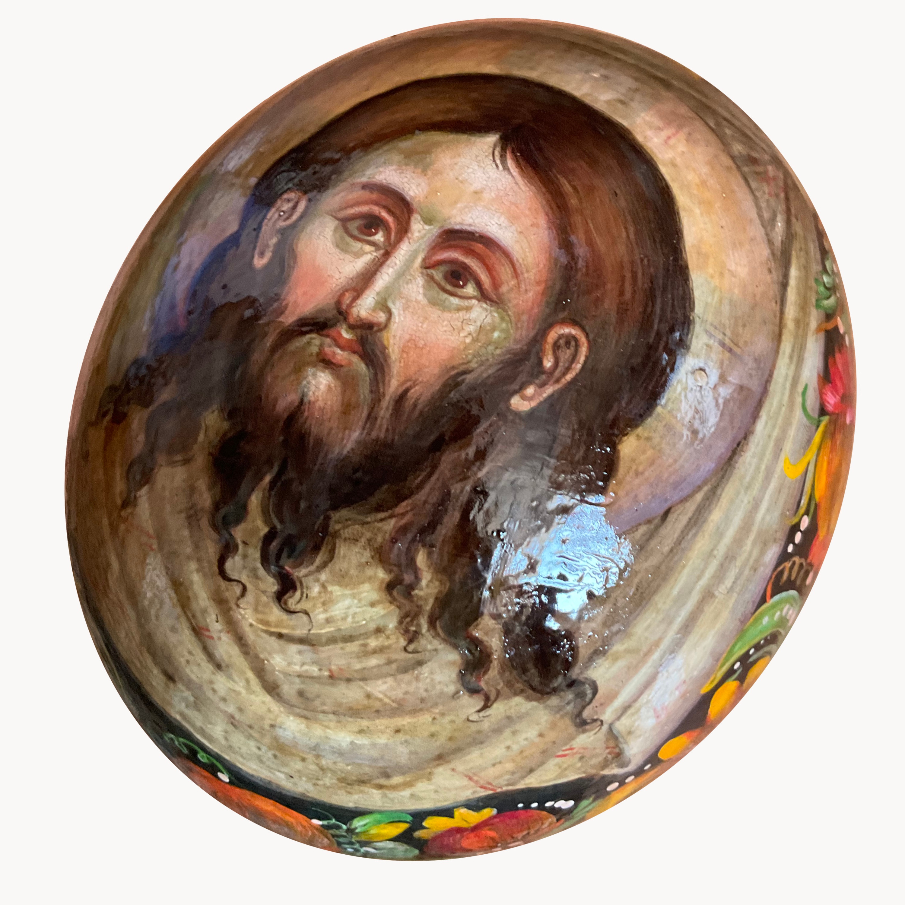 A painted ostrich egg on a stand.