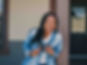 April Nicole Scipio leaning forward laughing