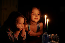 Kids Staring at Candles Glow