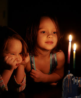 Kids Staring at Candles Glow