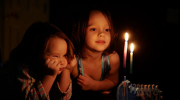 Kids Staring at Candles Glow