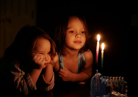 Kids Staring at Candles Glow