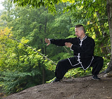 Sifu Bodhi doing qigong in the forest.