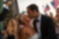 Cinematic wedding videography and photography of a bride and groom kissing during their outdoor ceremony