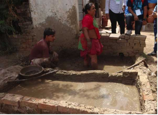 Woman mixing clay with her feet