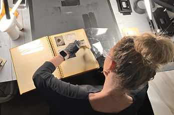 carefully removing photos from sticky album