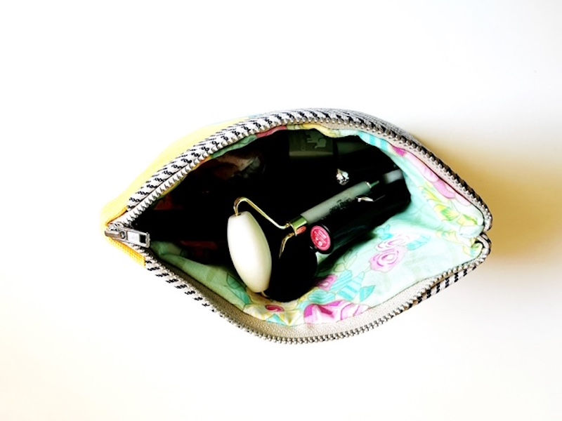 Thumbnail: close-up of aqua and yellow zipper pouch for durability