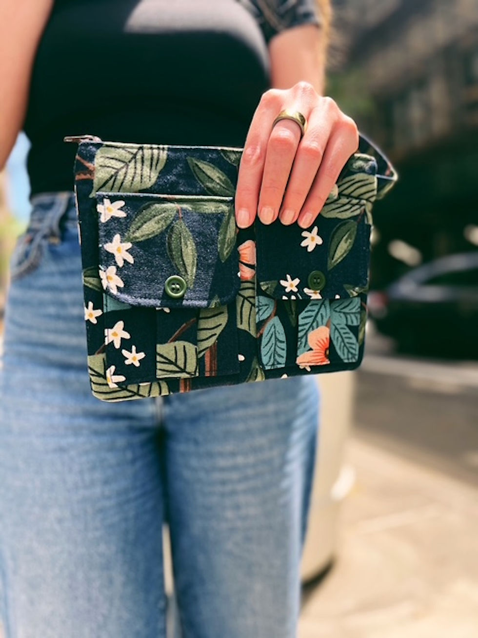 close-up of citrus grove floral print on black cotton canvas zipper wristlet wallet