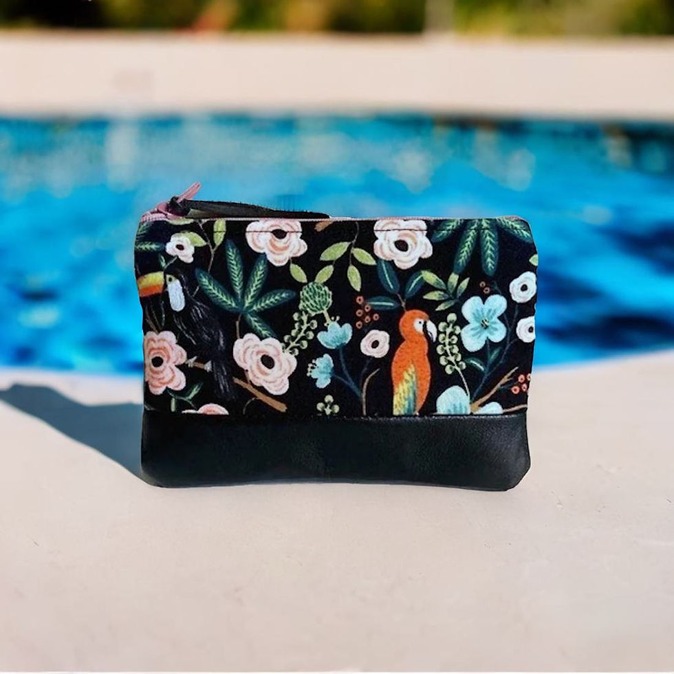 travel coin purse with a toucan and parrot design on a surface by a bright blue pool