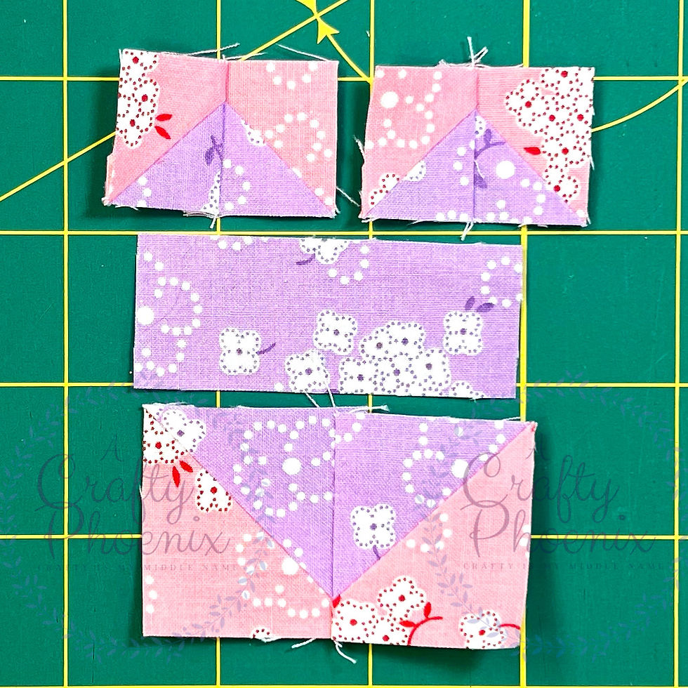 Seven pieces of fabric laid out in a heart shape. Six of the pieces are sewn together in pairs.
