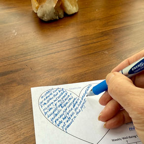 Filling in the weekly gratitude heart in the Passport Tracker Journal