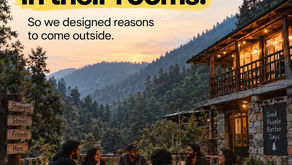 Travellers gathered around a bonfire outside a mountain hostel in Jibhi, illustrating community-focused common-area design.