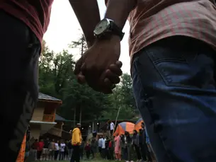 Two participants holding hands during a group activity