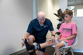 Physio treating leg injury