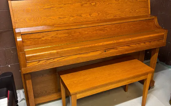 Yamaha P22 Studio Upright Piano closed view in brown wood finish at Rockafellow Piano in San Antonio, Texas