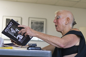 "Nancy Ava Miller browses through her semi-autobiographical book “Pervert” at People Exchanging Power Sunday. Miller is the founder of PEP, a local phone-sex company." Daily Lobo, "9/17_phonesex" by Arsenii Morin,
September 16, 2013.