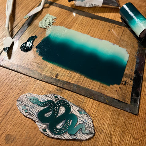 Gothic linocut print of The Serpent using green and white ink