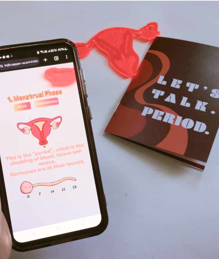 a phone screen showing the ar experience, the zine and the uterus cutout