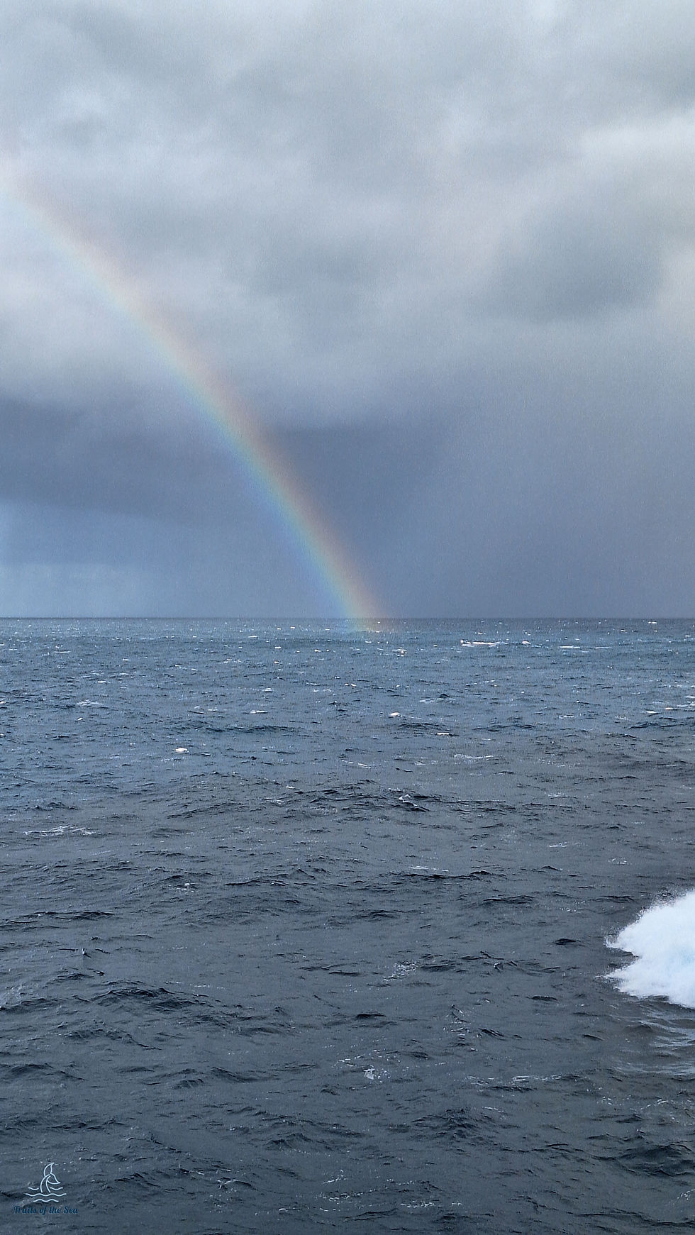Rainbow over a windy Atlantic Ocean