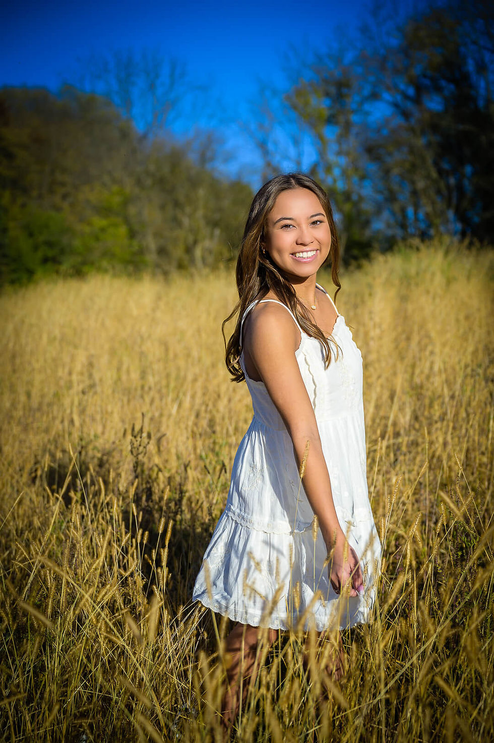 High School senior portrait in a field