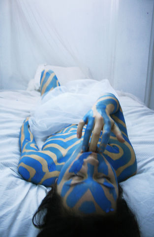 Photograph of a girl painted in blue lines by The Line Girl in abstract blue lines