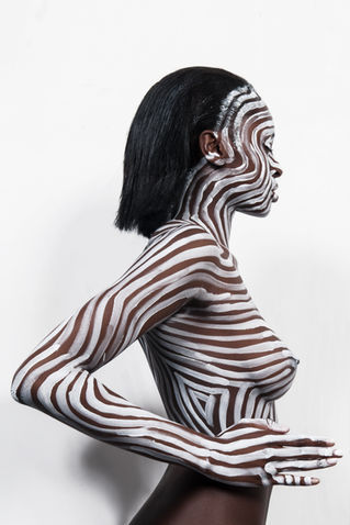 Photograph of a girl with her body painted by The Line Girl in white abstract lines
