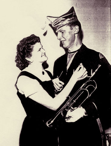 Lovebirds. Betty is pinning the Championship metal on Phil's uniform (about 1956)