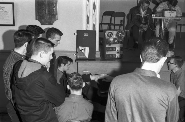 Corps members listening to a new song (Indoor, 1964)