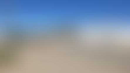 Co-op convenience store with gas pumps and parked white truck. Clear blue sky, signage reads "Co-op" and "131" on price board.