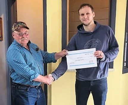 Norm White presents check to SWT Lyceum Theatre manager Cole Girodat