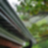 Seamless gutter installation on a house exterior