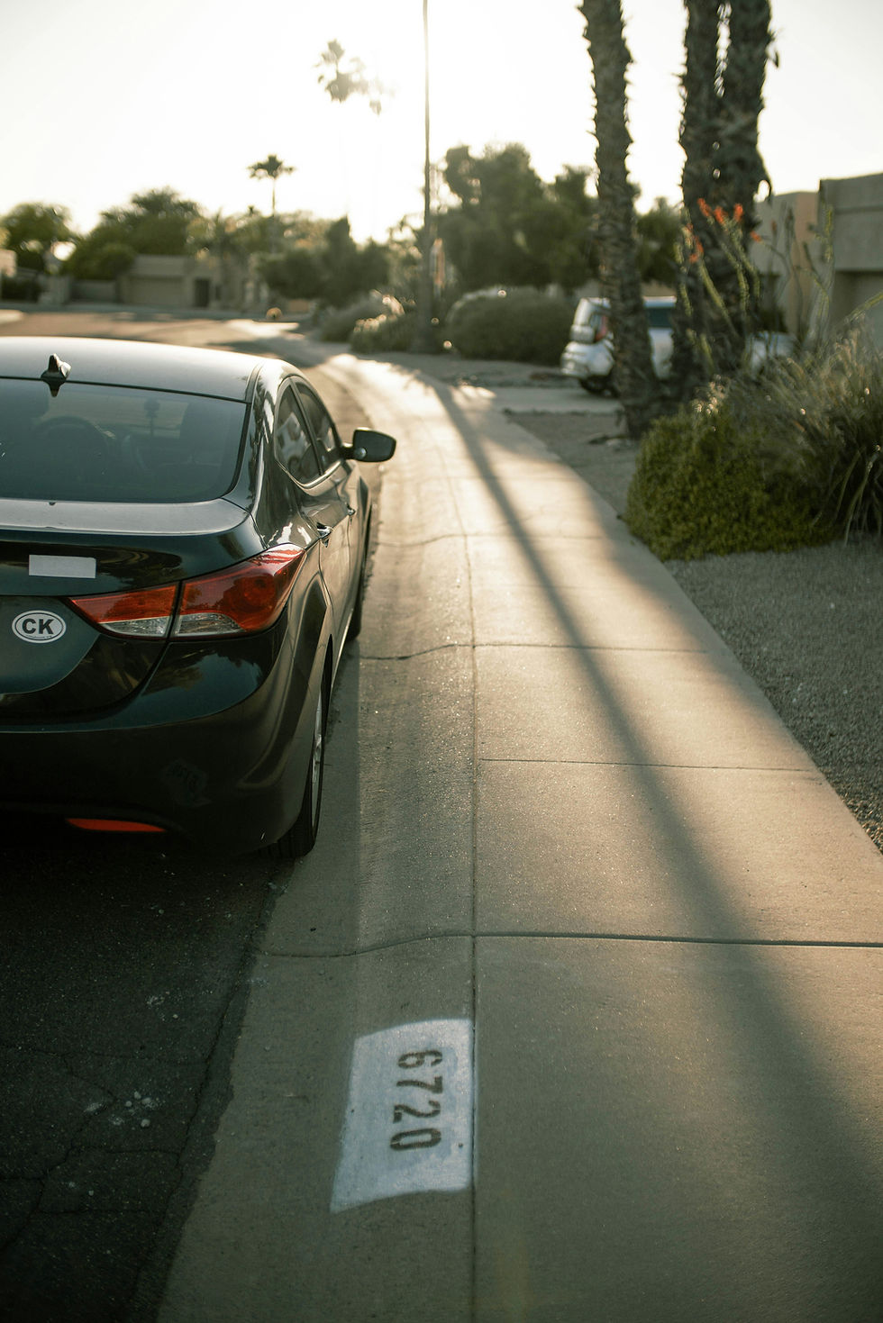 A parked sedan beside a curb in a Scottsdale, Arizona neighborhood.