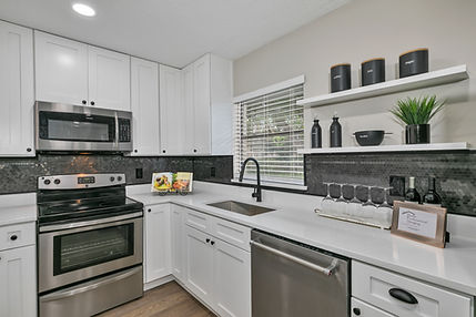 modern kitchen renovation with white cabinets and island in Orlando home