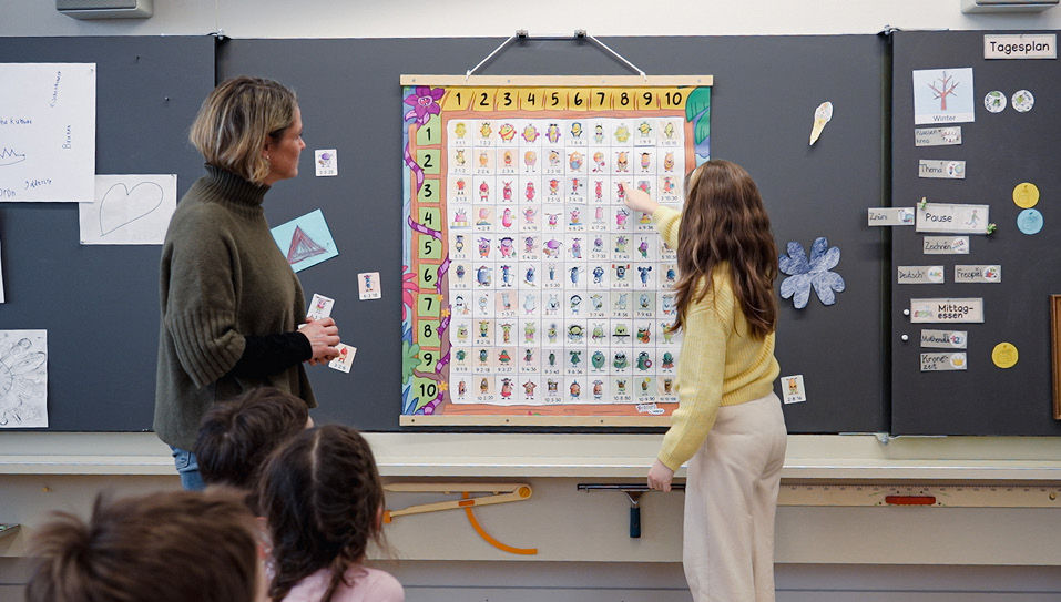 Eye-level view of colorful math game pieces on a wooden table