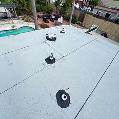 Performing a three-course type method on a torch down roof applying on all pipe flashings.